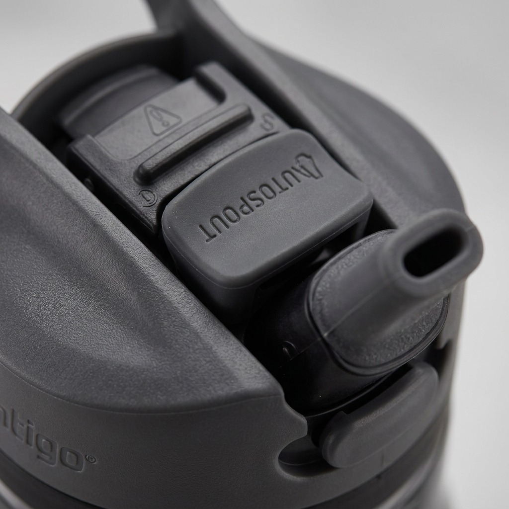 A macro photo of the dark gray Contigo Autospout water bottle, highlighting the AUTOSPOUT pop-up button.